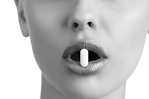 Pill supplement in lady's mouth