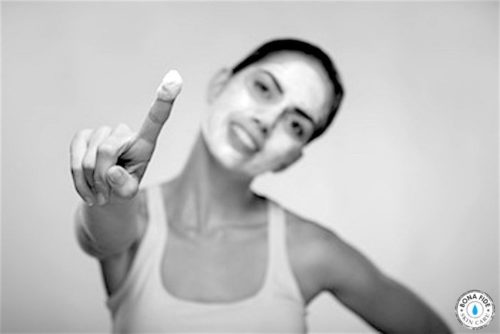 Girl with white mask on face and finger