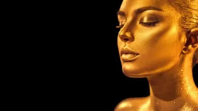 Woman with golden glowing skin