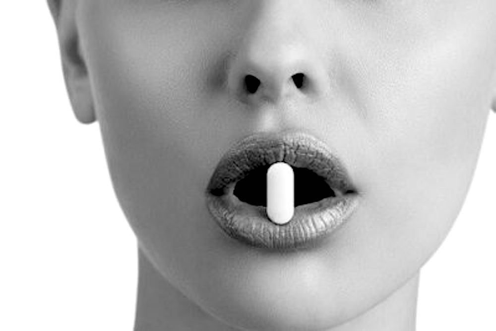 Pill supplement in lady's mouth